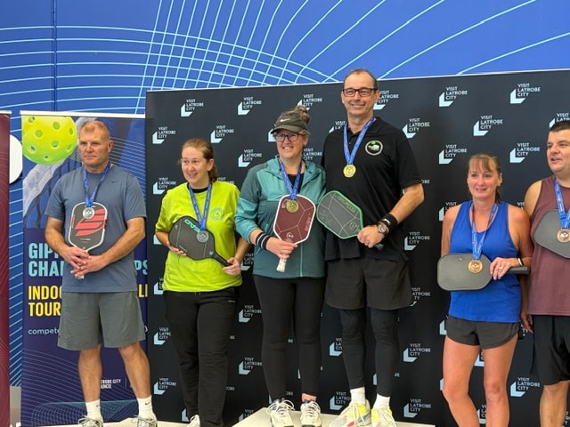 Row of pickleball club banners at an outdoor tournament event